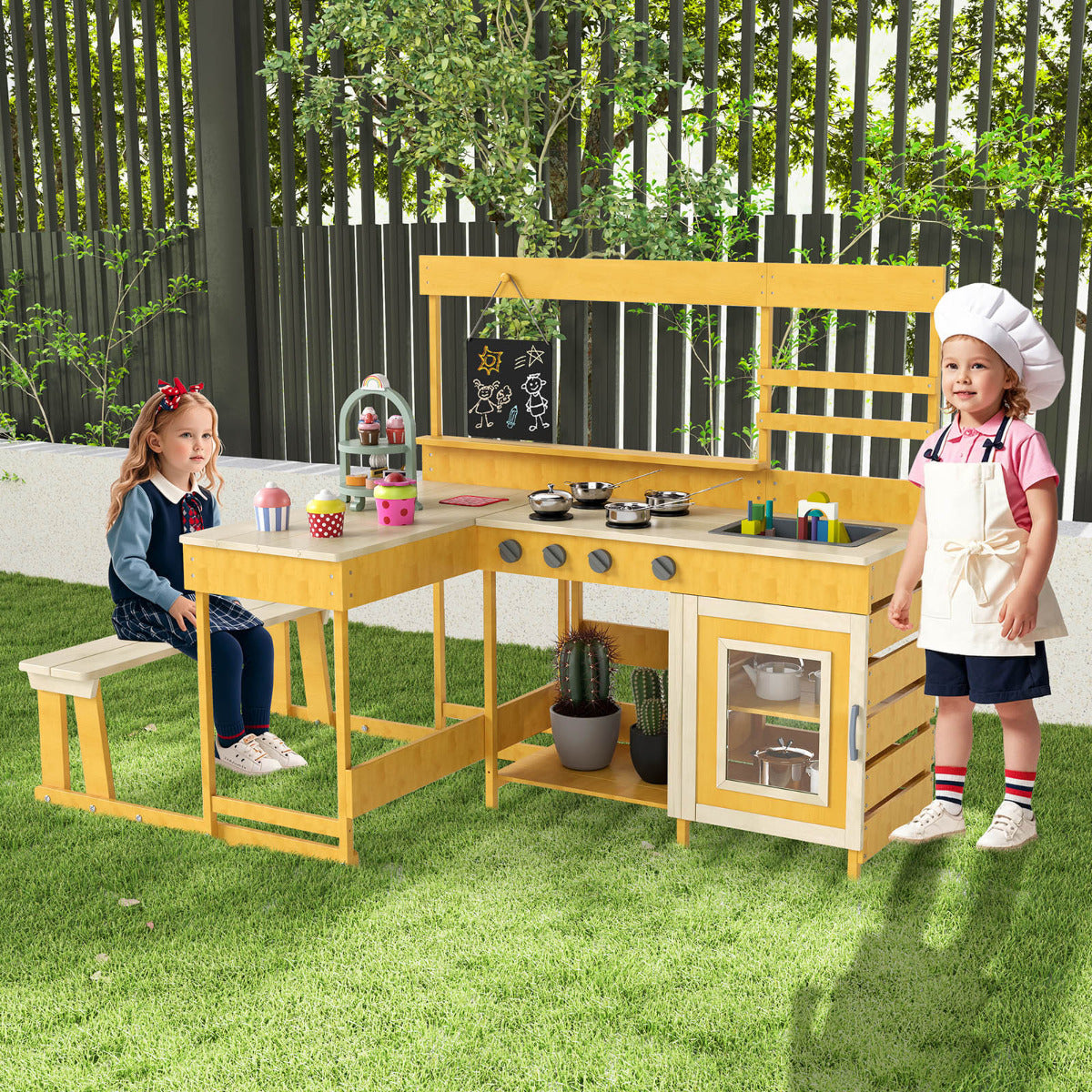 Children playing at the natural wood mud kitchen with picnic table in a garden setting
