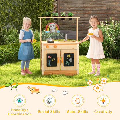 Two children playing with the wooden play kitchen set in a garden setting