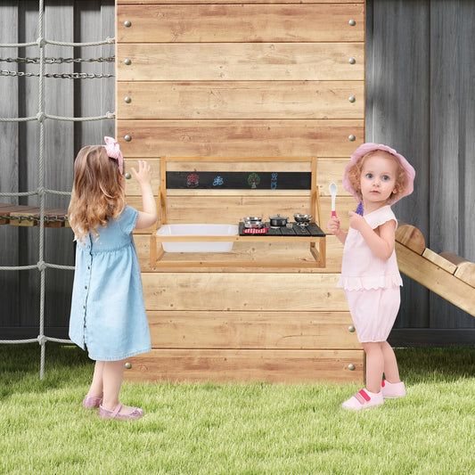 Two children playing at the wooden pretend play kitchen outdoors