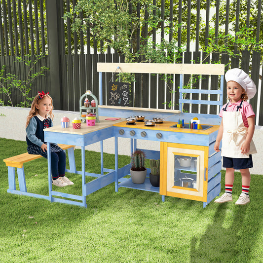 Children playing at the blue and yellow mud kitchen with picnic table in a garden