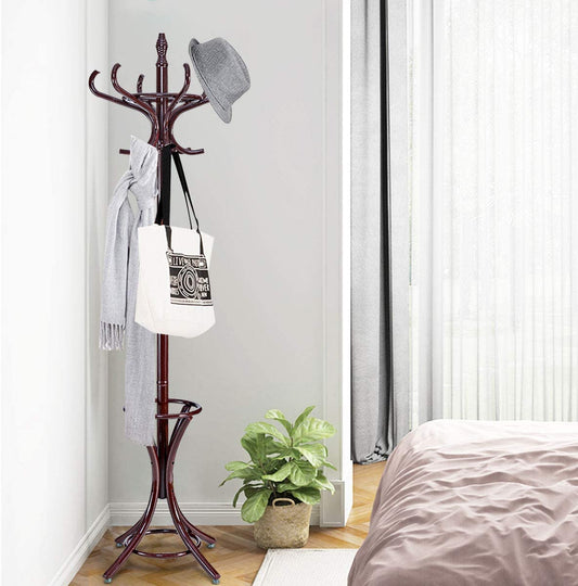 The coat rack is shown in a bedroom setting with a hat, scarf and bag hanging on it