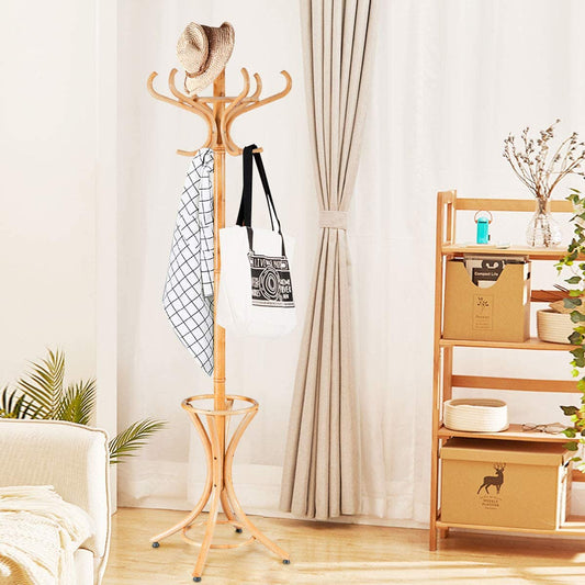 The coat rack standing in a bright living room with a hat and bags hanging from the hooks