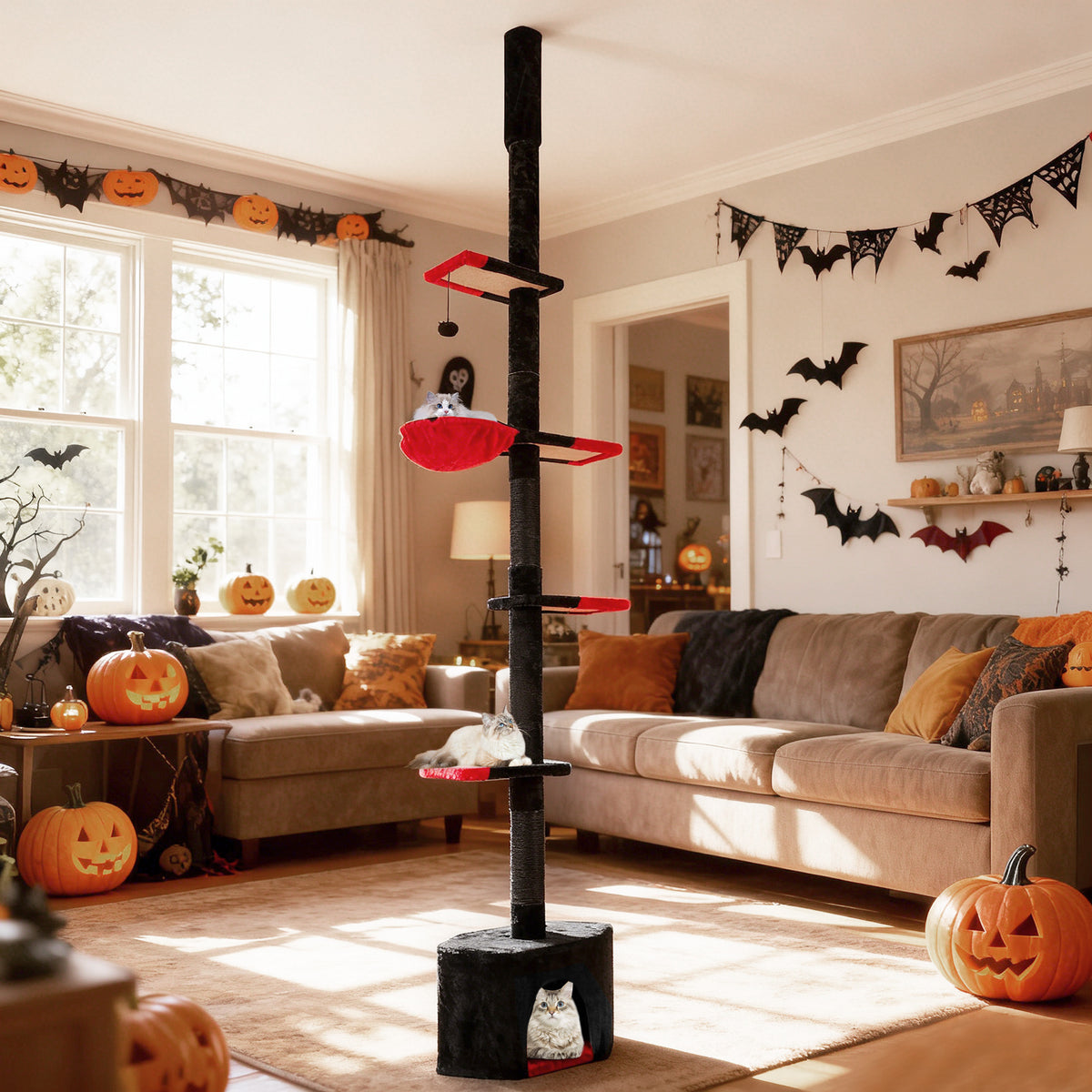 The tall cat tree is set up in a living room decorated for Halloween with pumpkins and banners