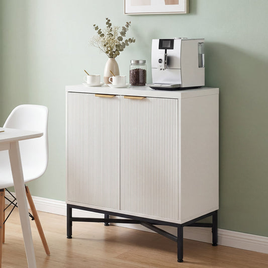 White cabinet with two doors and gold handles in a kitchen setting with a coffee machine