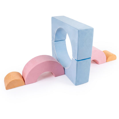 A set of macaron coloured foam climbing blocks arranged on a white background