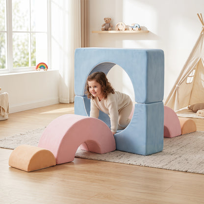 A young girl crawling through a tunnel made of soft play blocks