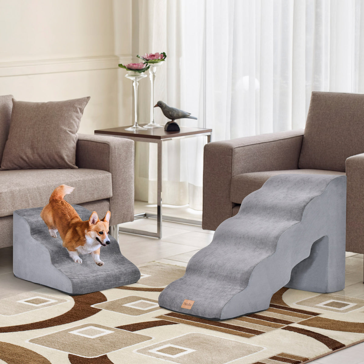 Two grey foam pet stairs set up in a living room with dogs
