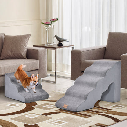 Two grey foam pet stairs set up in a living room with dogs