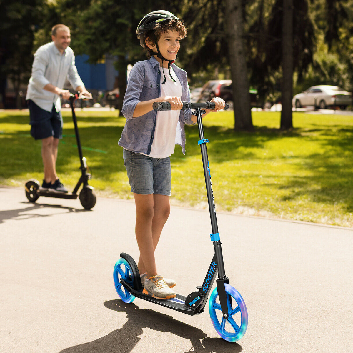 A boy riding the blue kick scooter with LED wheels on a paved path