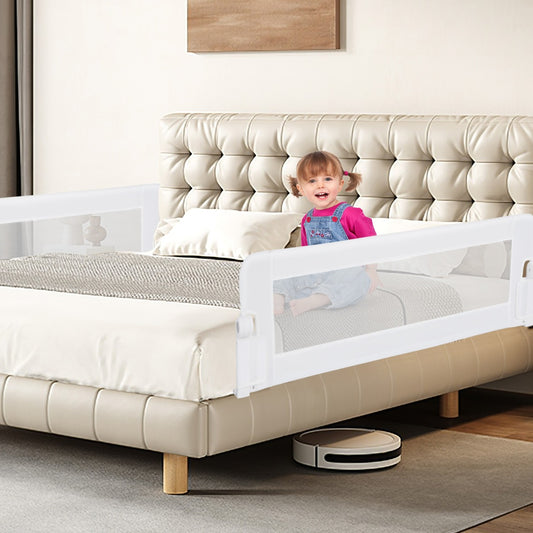 Toddler sitting on a bed with the white bed rail installed, showing the product in use