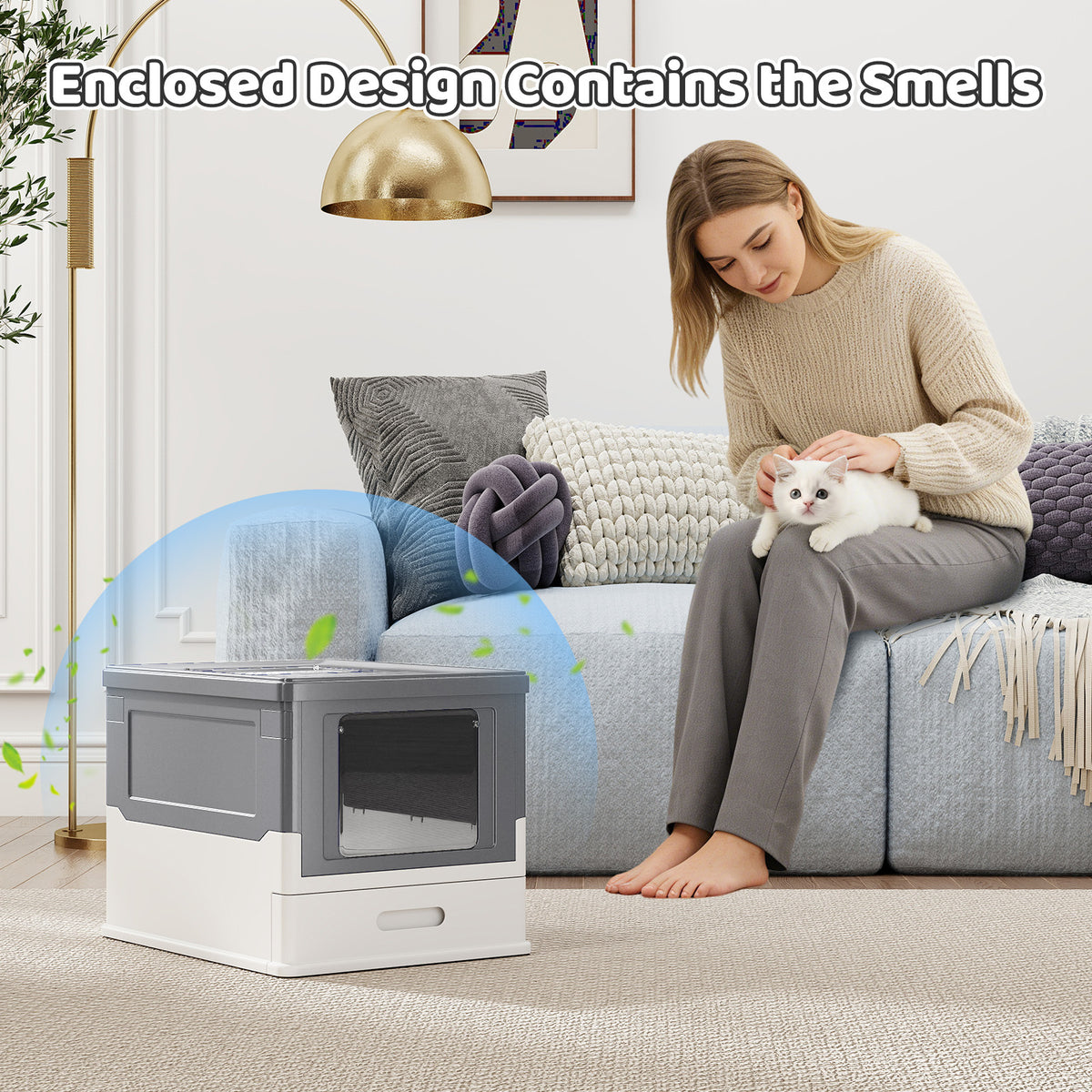 A woman holds a cat next to the enclosed cat toilet in a room setting
