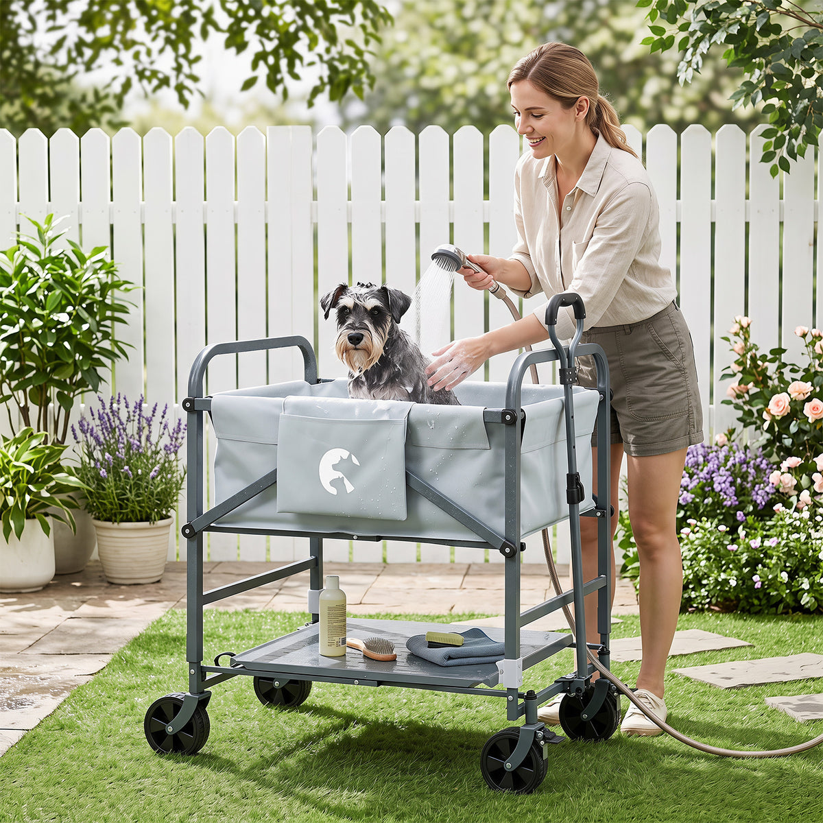 The foldable dog bath cart shown outdoors with a woman washing a dog in a garden