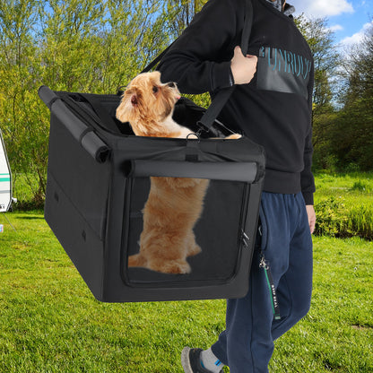 A person carrying the dog crate with a dog inside, outdoors in a grassy area