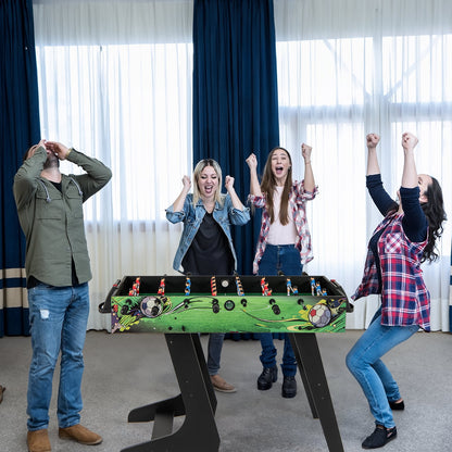 Four friends cheering and celebrating a victory around the green game table indoors