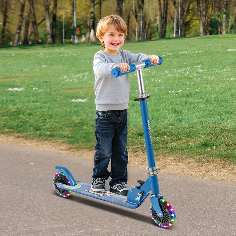 Young boy happily riding the blue scooter with flashing wheels in a park