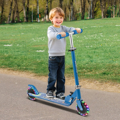 Young boy happily riding the blue scooter with flashing wheels in a park
