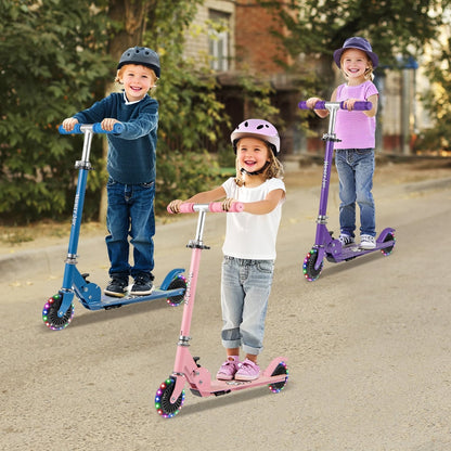 Three children, two boys and a girl, riding blue, pink and purple scooters