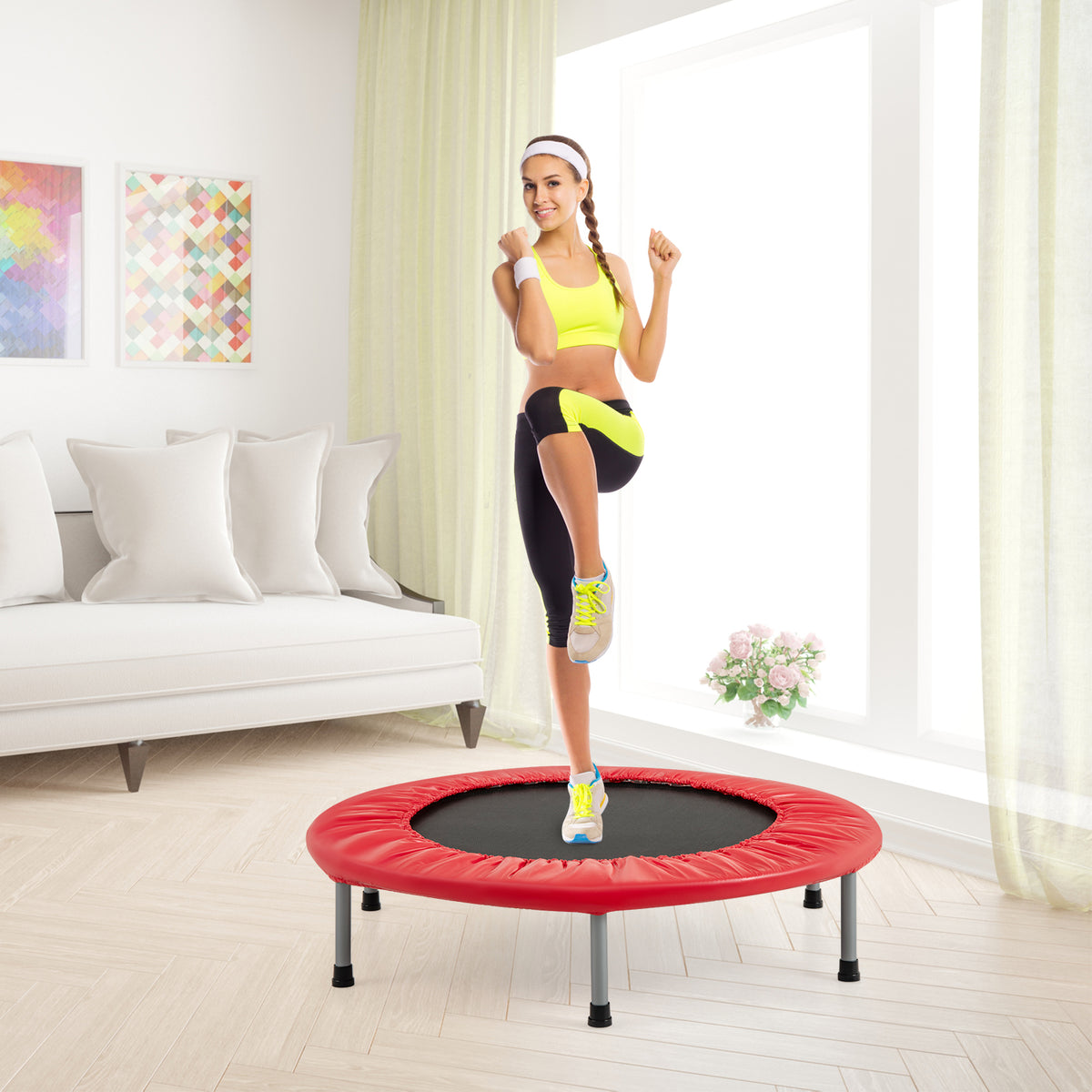 A woman exercising on the red trampoline in a living room