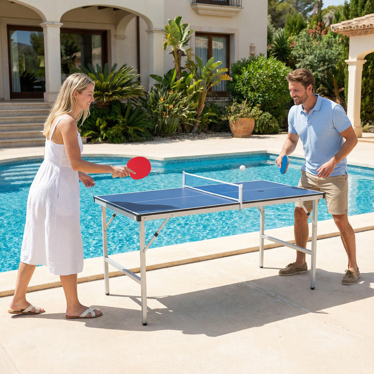 A couple playing ping pong next to a swimming pool outdoors