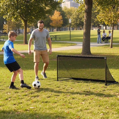Father and son playing soccer with the pop-up goal in a park