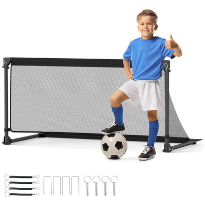 Boy giving a thumbs up next to the pop-up soccer goal with a football
