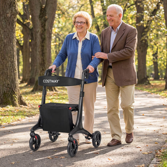 Elderly couple walking with the rollator walker in a park