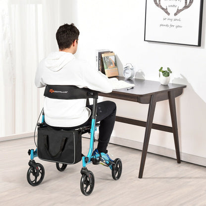 Man sitting at a desk using the blue rollator walker mobility aid indoors