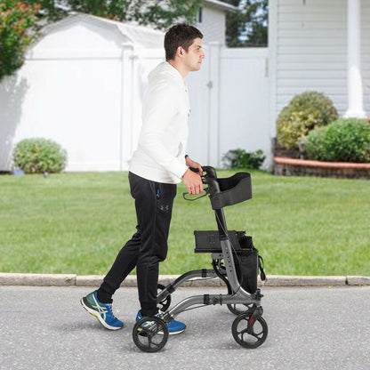 The mobility walker being pushed by a man walking along a paved path in a garden setting