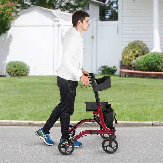 A man walks with the red four-wheeled walker on a paved path outdoors