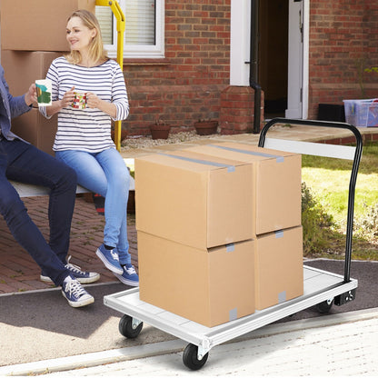 Two people sitting on a bench next to the aluminium platform truck with boxes