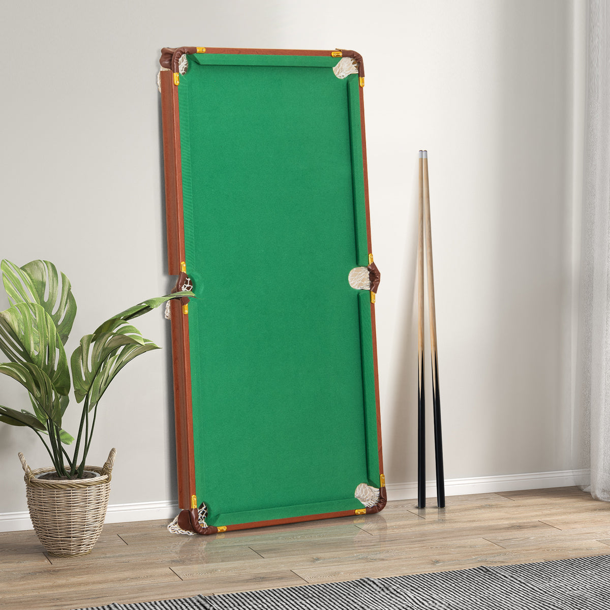The folded billiards table leaning against a wall