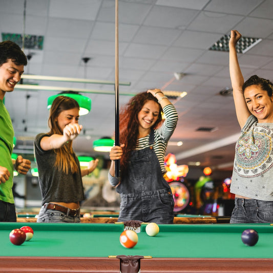 Friends enjoying a game on the billiards table