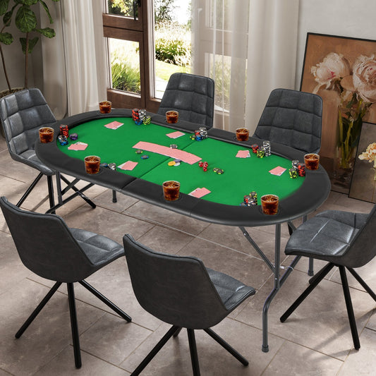 The green game table is set up with chairs around it, cards and poker chips on the felt surface