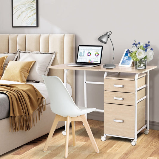 The office desk is shown in a bedroom setting with a bed and chair