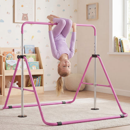 The training bar positioned in a nursery with a child hanging upside down from the purple frame