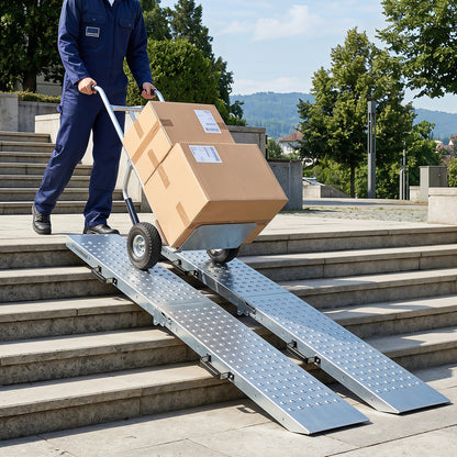 The metal ramps placed over stone steps to help move a trolley with boxes