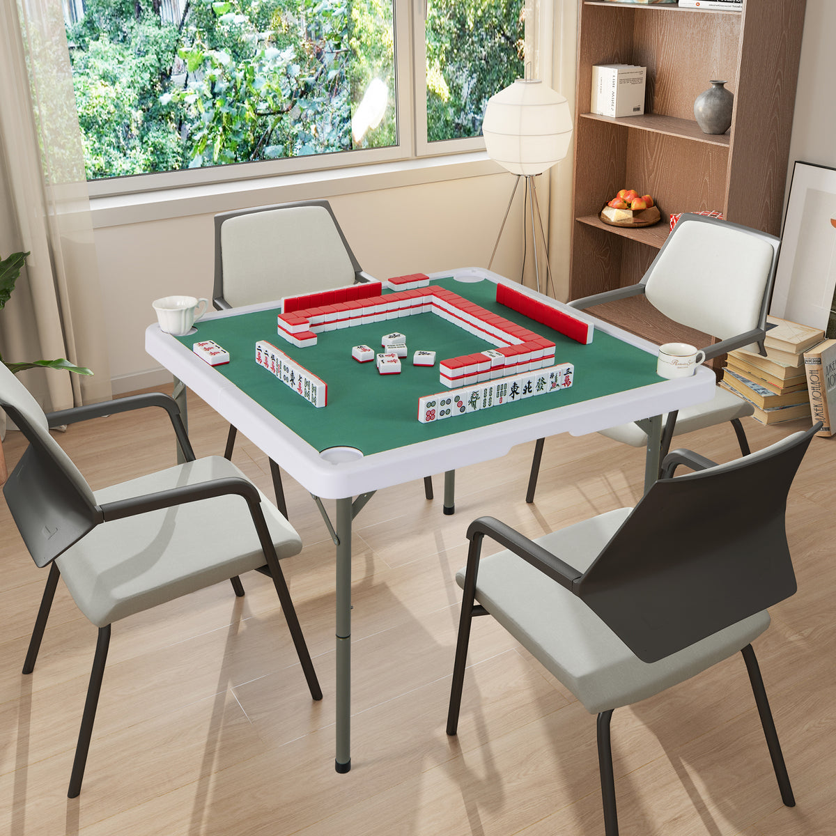 The game table set up in a bright room with four chairs around it for playing