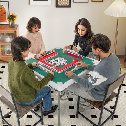 The game table in use with four people sitting around it playing a game