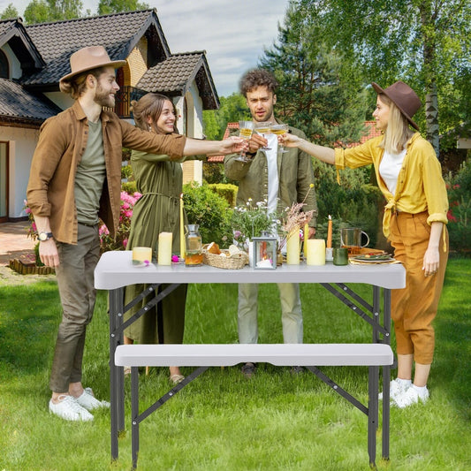 A group of four friends toasting drinks around the patio table set in a garden