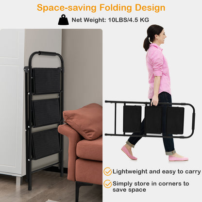 A woman carrying the folded black portable step ladder