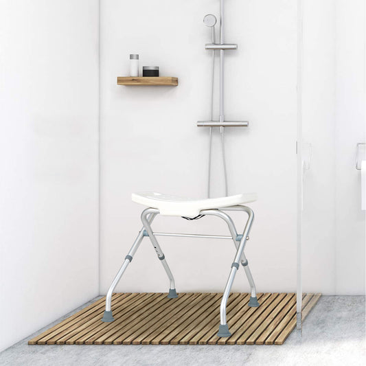 The bath safety seat in a modern shower cubicle on a wooden mat