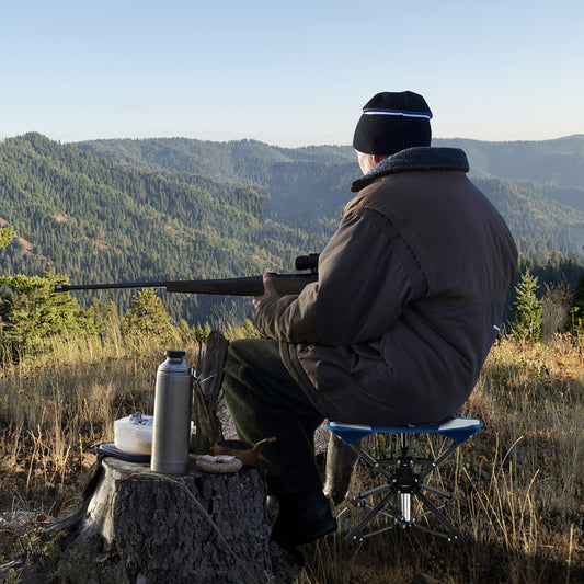 The camping stool being used by a hunter outdoors