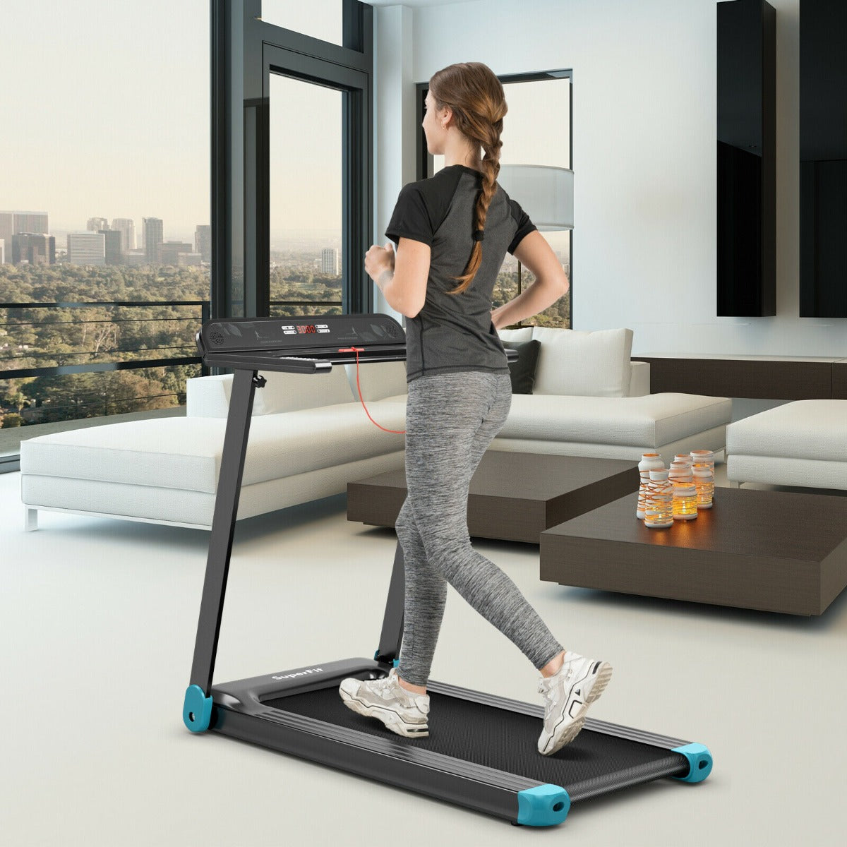 Woman running on the blue folding treadmill in a modern living room