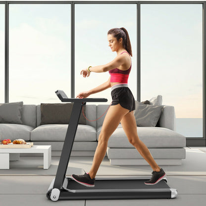 A woman checks her smartwatch while running on the treadmill in a living room