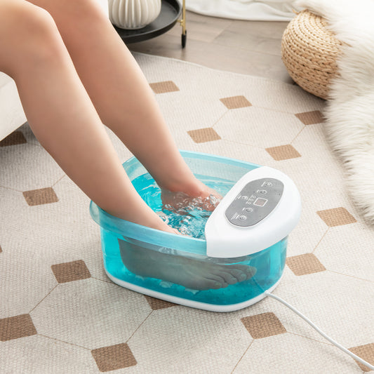 The foot massager filled with water and in use by a person sitting on a rug in a living room