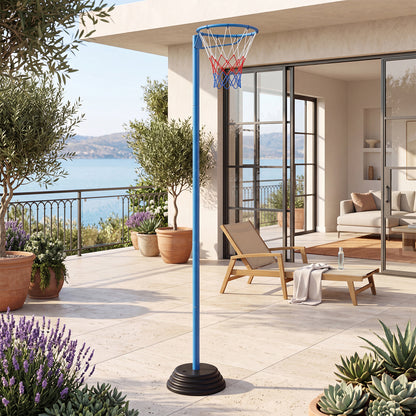 The basketball goal is set up on a patio with a sea view