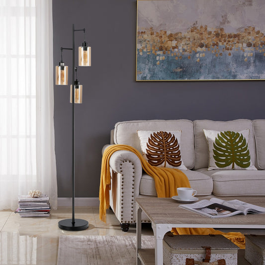 The floor lamp with three amber glass shades in a modern living room setting next to a sofa