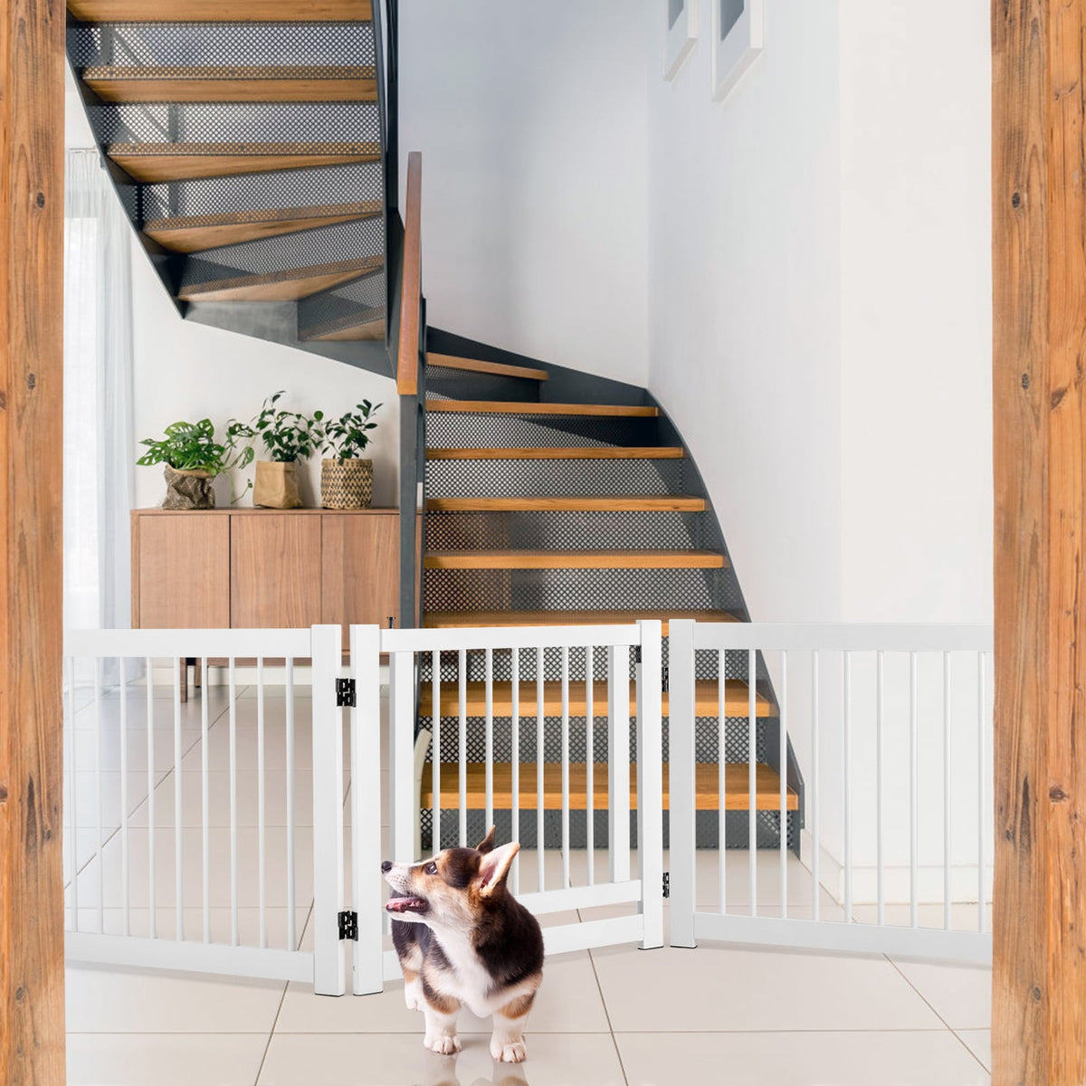 The pet gate is positioned at the bottom of stairs with a dog