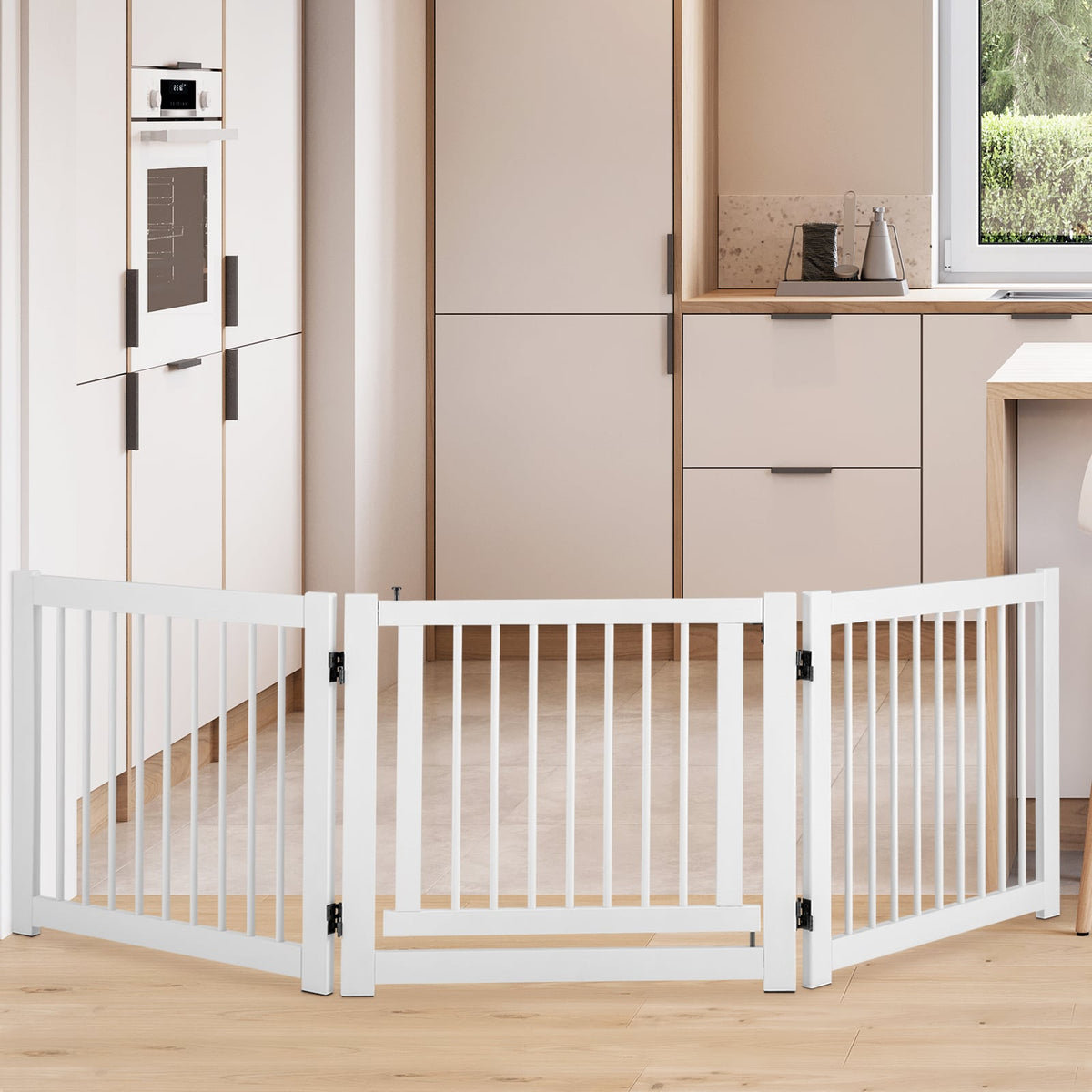 The white pet gate is set up in a modern kitchen