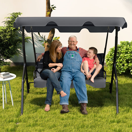 A family enjoys relaxing on the grey metal garden patio swing lounger on a sunny day
